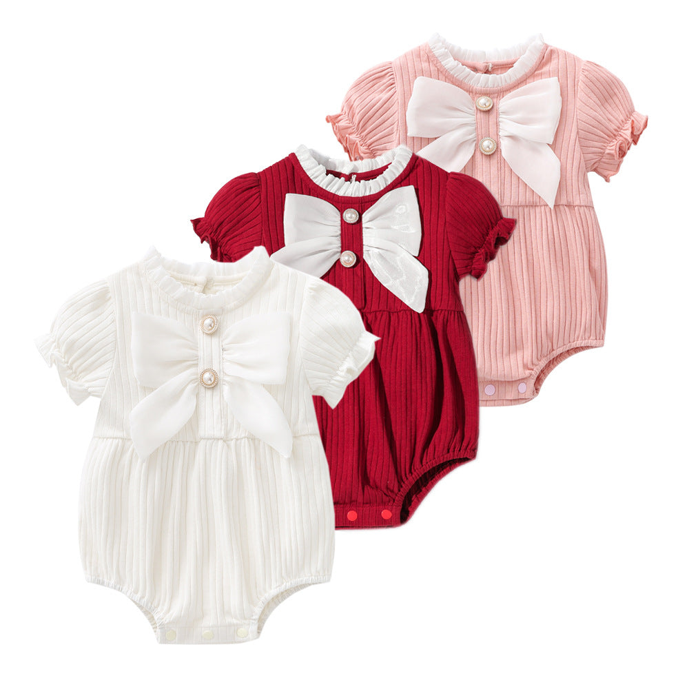 Baby girls solid color lace design puff-sleeved onesies in white, red, and pink, featuring a bow decoration.