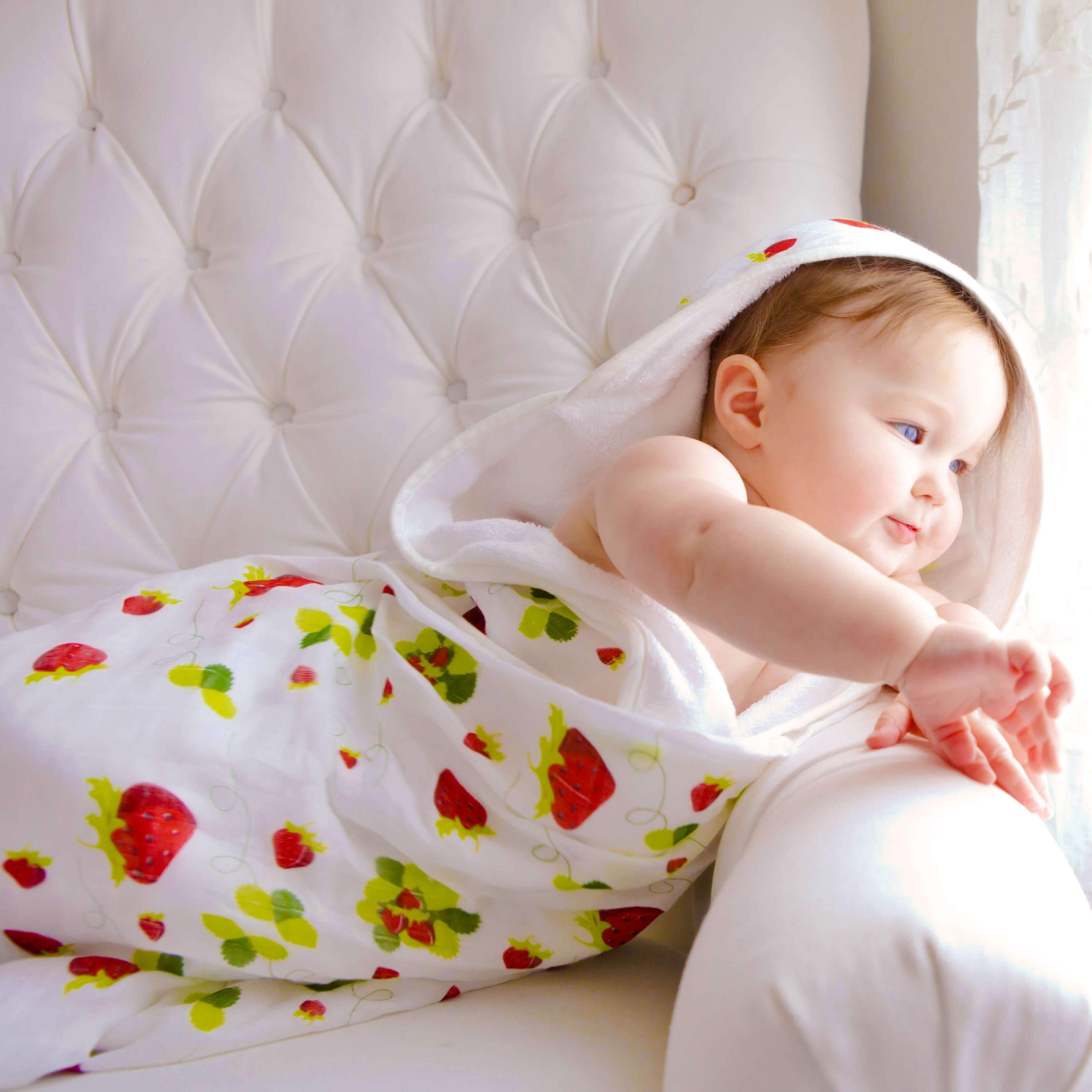 Baby hooded towel featuring a strawberry print, made from buttery soft terry and muslin, perfect for newborns to toddlers.