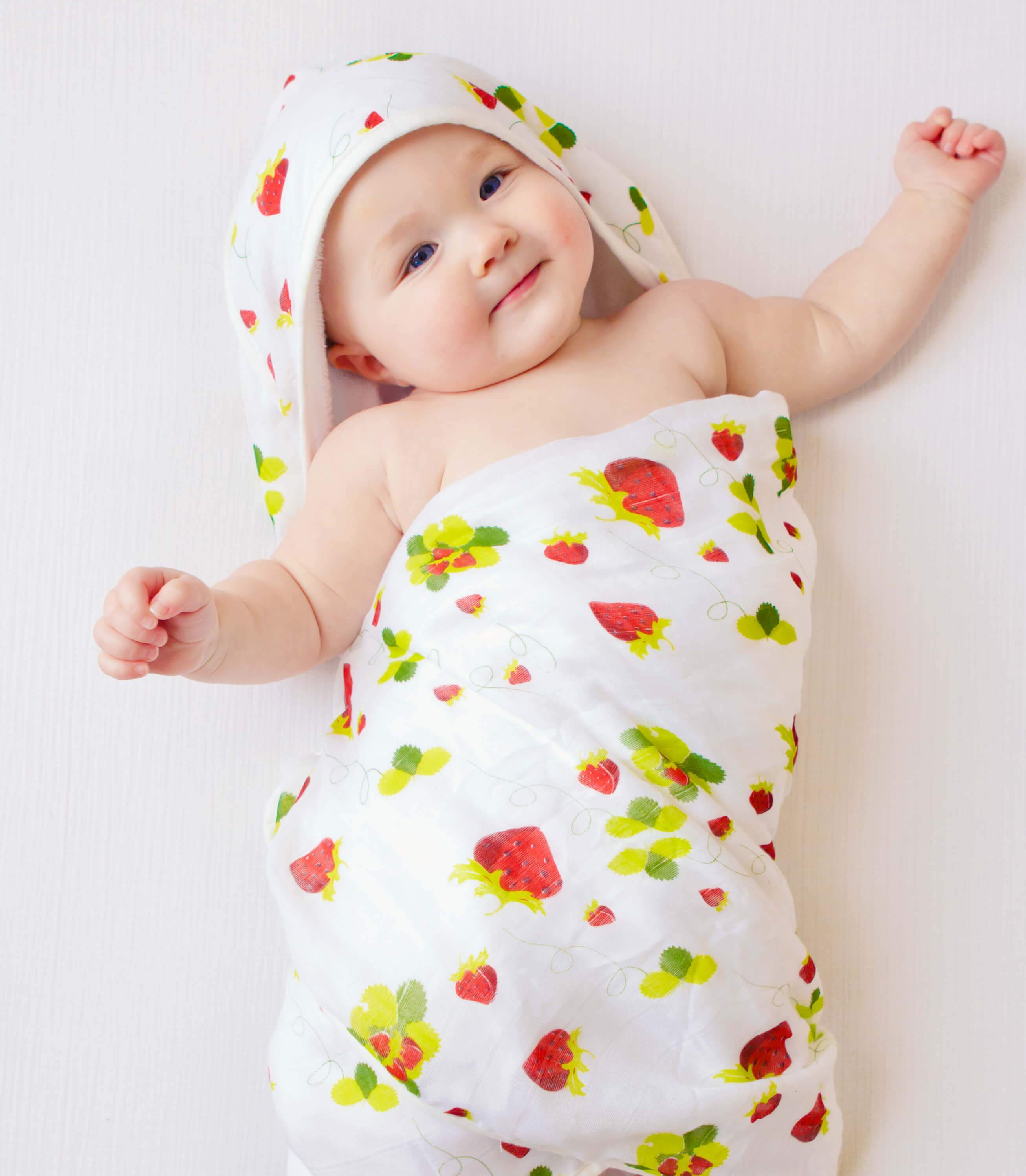 Baby hooded towel featuring a strawberry print, made from buttery soft terry and muslin, perfect for newborns to toddlers.