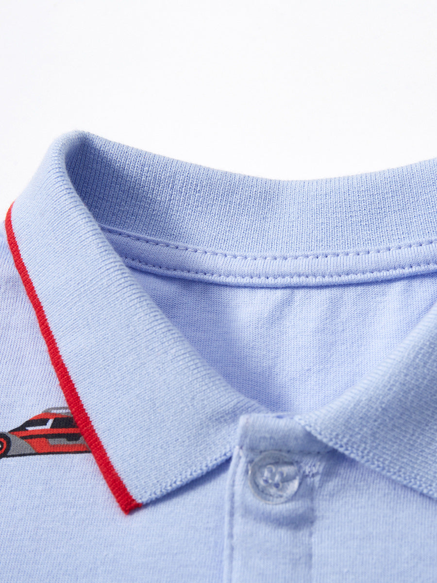 Baby boys blue polo shirt with racing car print, short sleeves, made of cotton, perfect for spring and summer wear.