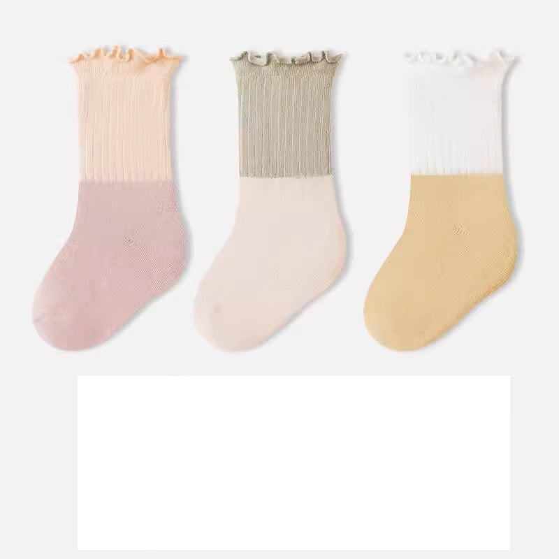 A variety of Baby Kids Unisex Patchwork Comfortable Mid-Calf Socks in multiple colors including white, pink, blue, green, yellow, beige, and brown.