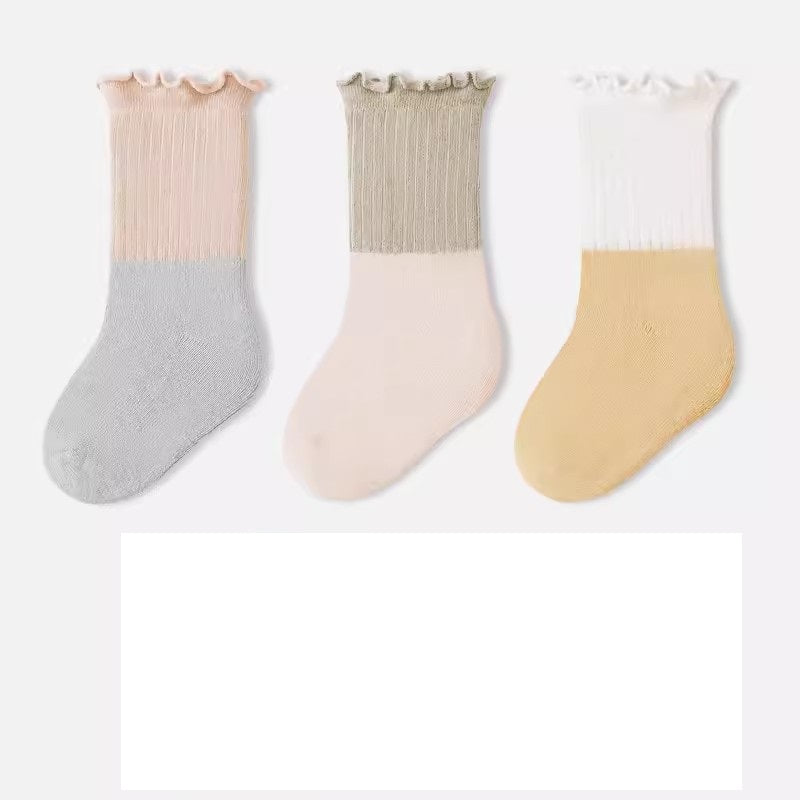 A variety of Baby Kids Unisex Patchwork Comfortable Mid-Calf Socks in multiple colors including white, pink, blue, green, yellow, beige, and brown.