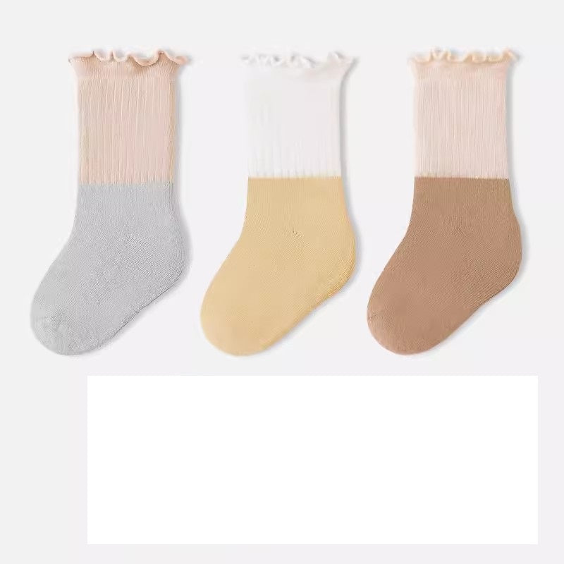 A variety of Baby Kids Unisex Patchwork Comfortable Mid-Calf Socks in multiple colors including white, pink, blue, green, yellow, beige, and brown.