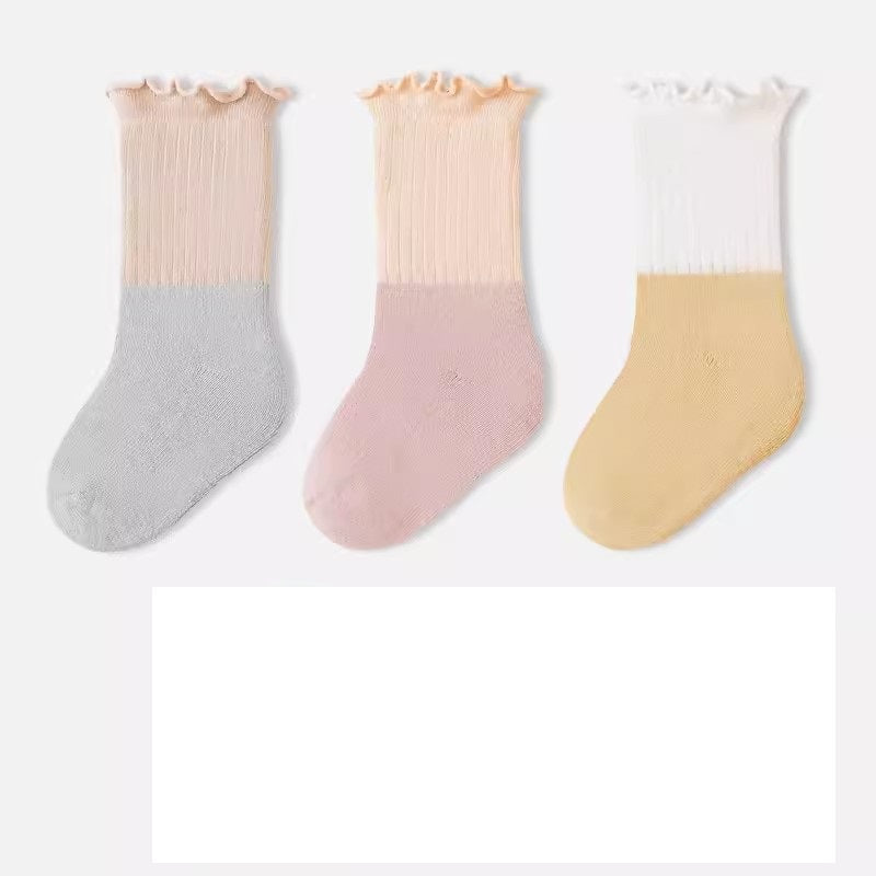 A variety of Baby Kids Unisex Patchwork Comfortable Mid-Calf Socks in multiple colors including white, pink, blue, green, yellow, beige, and brown.