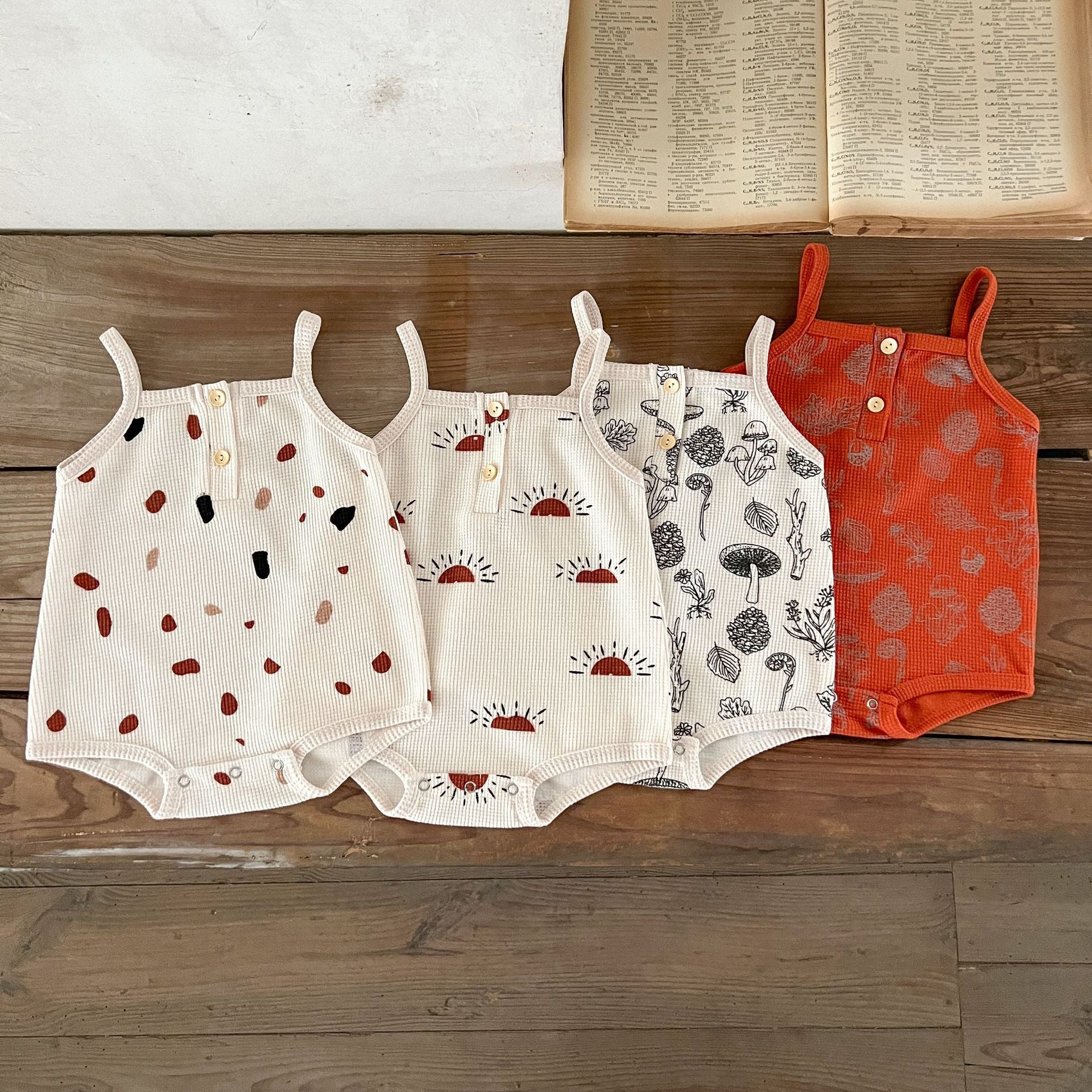 A collection of Baby Multi-Pattern Sling Soft Cotton Loose Casual Onesies in various colors and patterns, showcasing their soft fabric and stylish design.