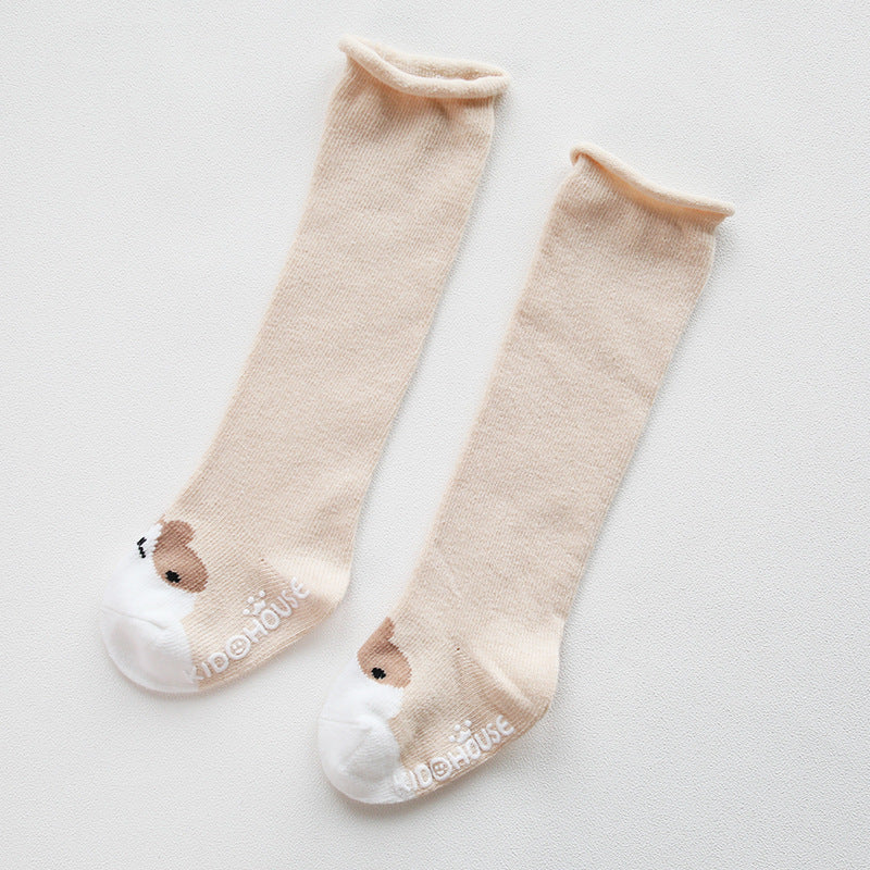 A pair of baby non-slip over the knee soft cotton high tube socks featuring cute animal and cartoon patterns, ideal for comfort and safety.