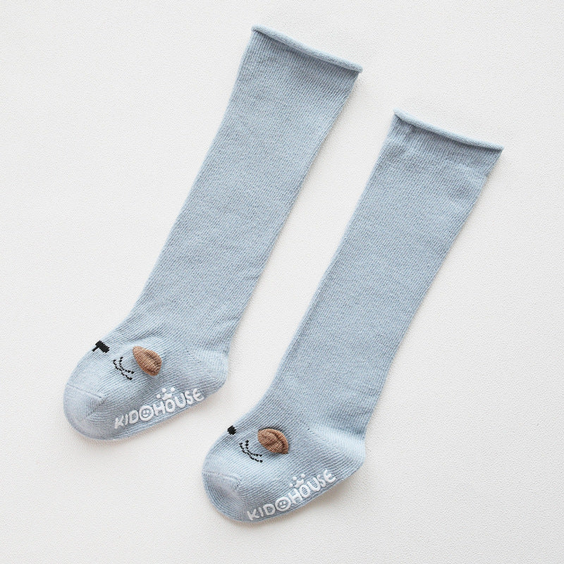 A pair of baby non-slip over the knee soft cotton high tube socks featuring cute animal and cartoon patterns, ideal for comfort and safety.