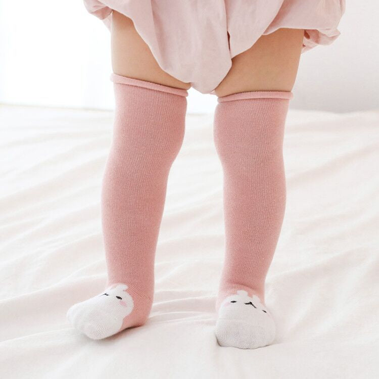 A pair of baby non-slip over the knee soft cotton high tube socks featuring cute animal and cartoon patterns, ideal for comfort and safety.