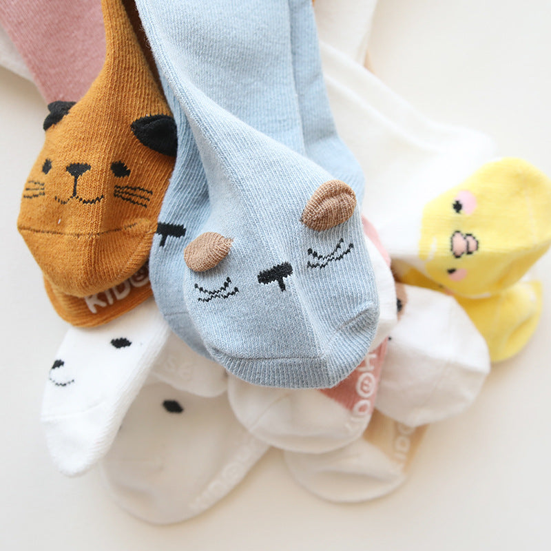 A pair of baby non-slip over the knee soft cotton high tube socks featuring cute animal and cartoon patterns, ideal for comfort and safety.