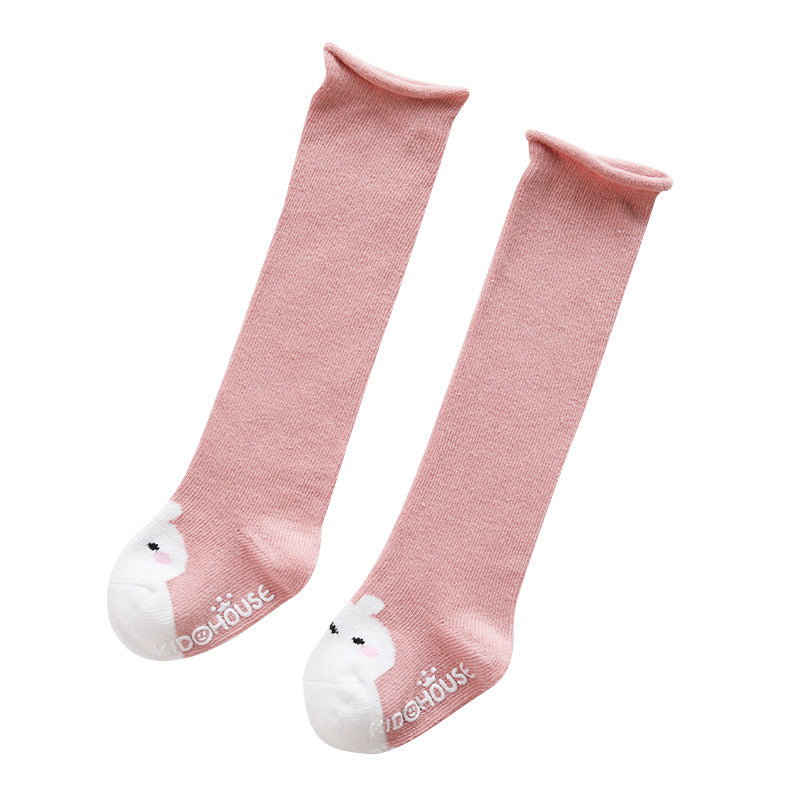 A pair of baby non-slip over the knee soft cotton high tube socks featuring cute animal and cartoon patterns, ideal for comfort and safety.