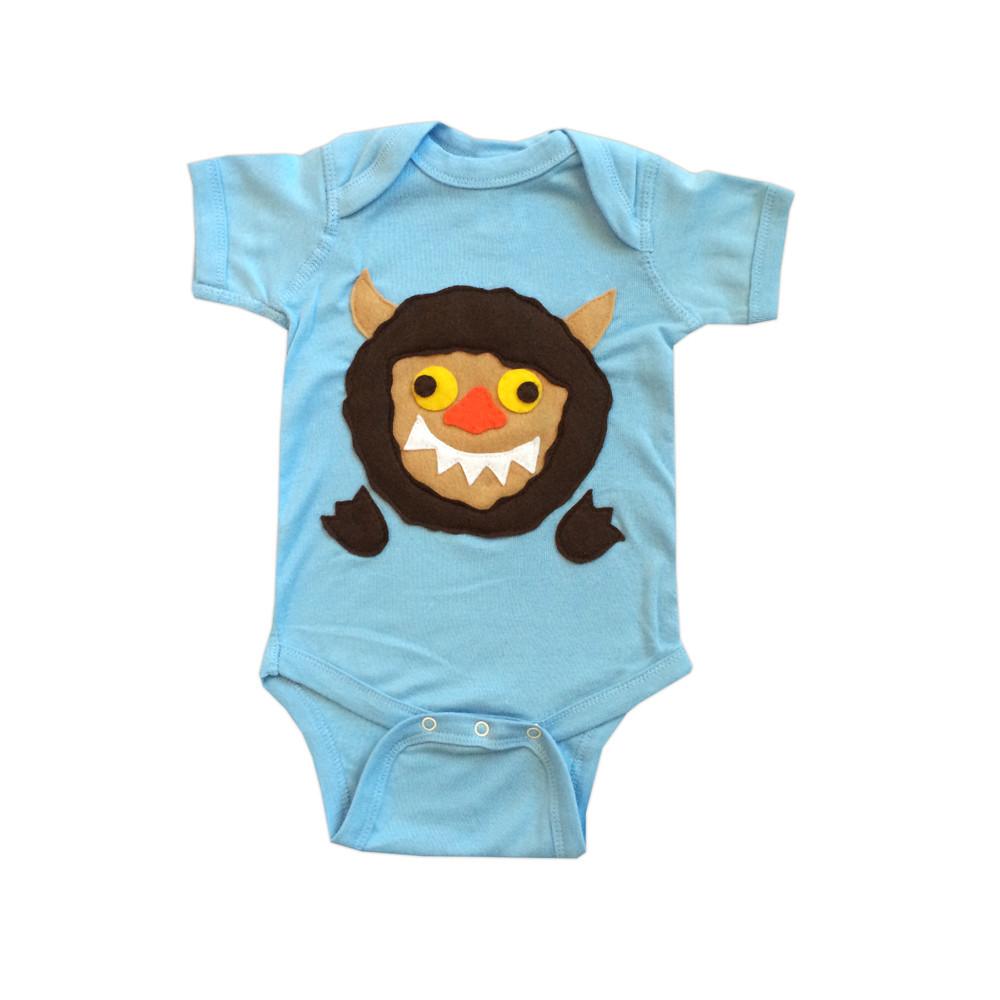 A handmade baby onesie featuring a cute wild monster design, perfect for infants and toddlers.