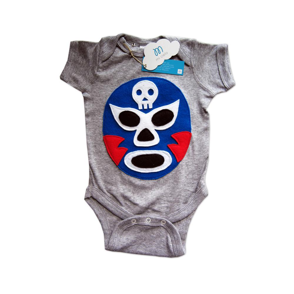 A vibrant blue baby onesie featuring a colorful Luchador Azul design, showcasing a playful Mexican wrestler character, perfect for infants.