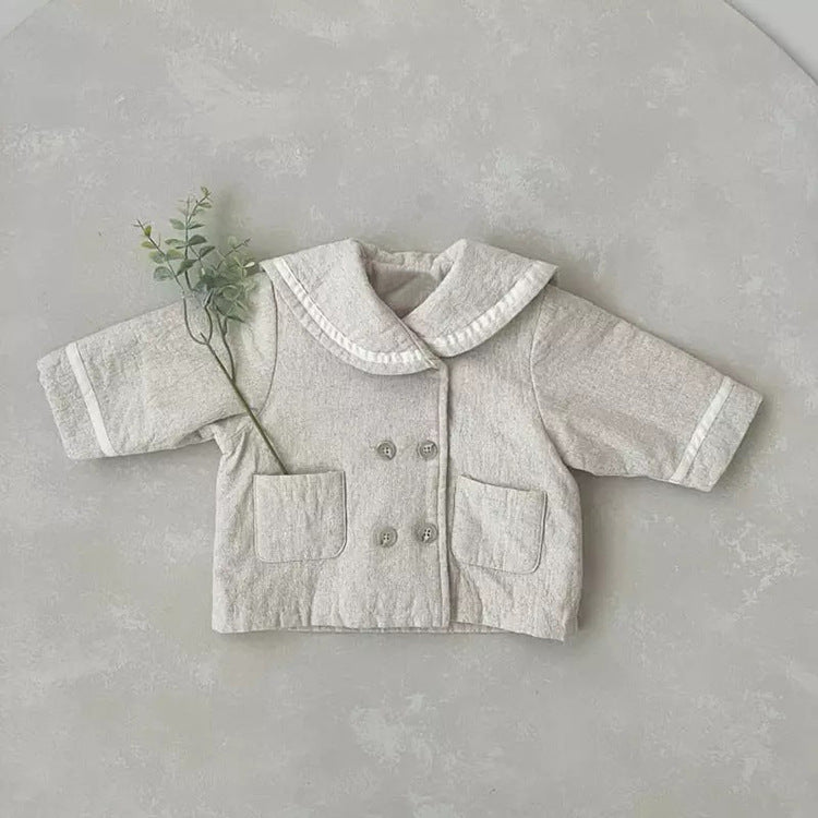 A stylish baby quilted coat featuring a plaid pattern and lapel design, available in black and apricot colors.