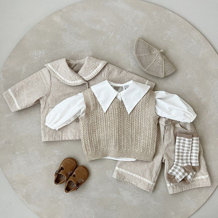 A stylish baby quilted coat featuring a plaid pattern and lapel design, available in black and apricot colors.