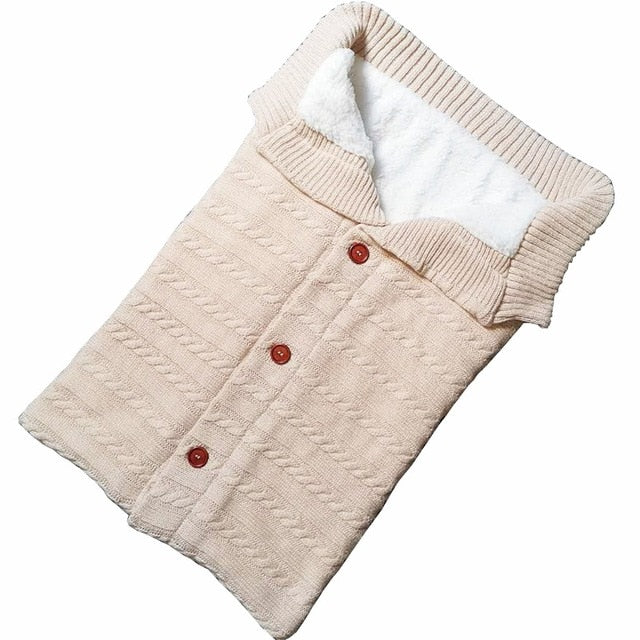 A cozy Baby Sleeping Bag Envelope in various colors, designed for infants, featuring a warm wool exterior and soft polar fleece lining.