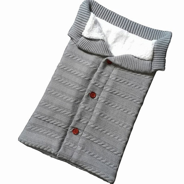 A cozy Baby Sleeping Bag Envelope in various colors, designed for infants, featuring a warm wool exterior and soft polar fleece lining.