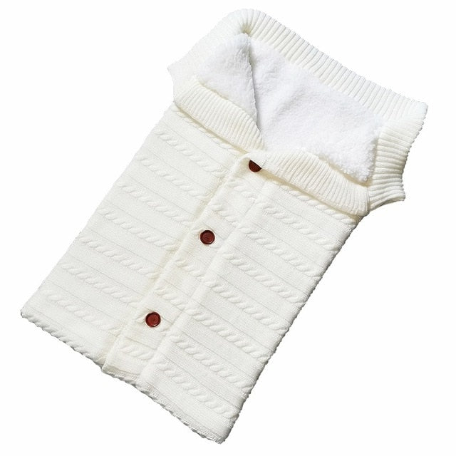 A cozy Baby Sleeping Bag Envelope in various colors, designed for infants, featuring a warm wool exterior and soft polar fleece lining.