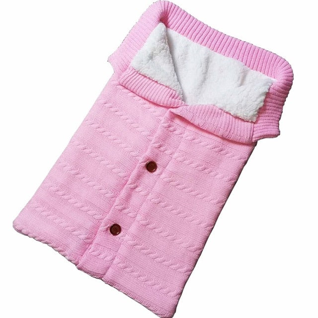 A cozy Baby Sleeping Bag Envelope in various colors, designed for infants, featuring a warm wool exterior and soft polar fleece lining.