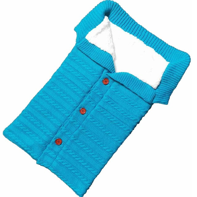 A cozy Baby Sleeping Bag Envelope in various colors, designed for infants, featuring a warm wool exterior and soft polar fleece lining.