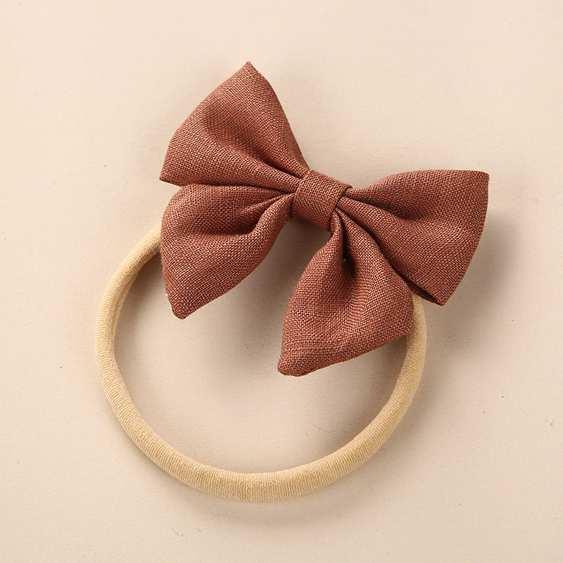 A collection of Baby Solid Color 3D Bow Handmade Elastic Headbands in various colors, showcasing their soft cotton material and adjustable design.