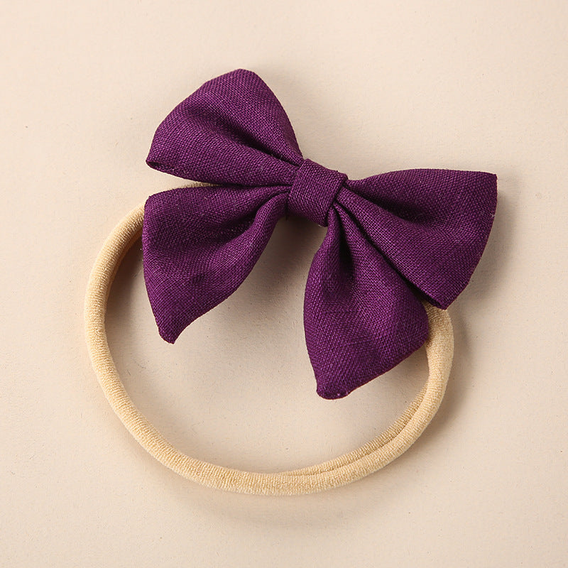 A collection of Baby Solid Color 3D Bow Handmade Elastic Headbands in various colors, showcasing their soft cotton material and adjustable design.