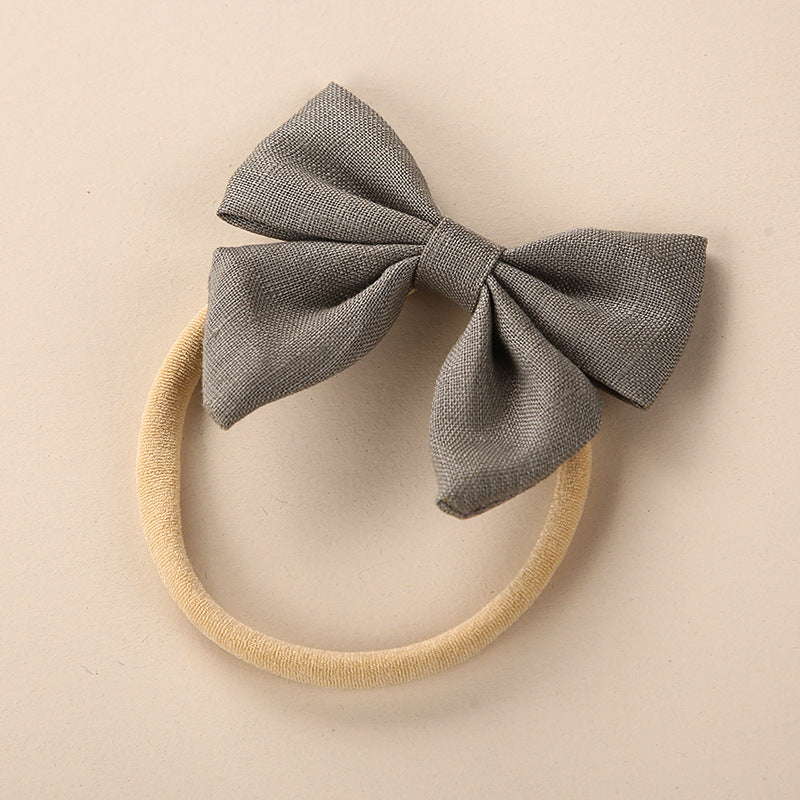 A collection of Baby Solid Color 3D Bow Handmade Elastic Headbands in various colors, showcasing their soft cotton material and adjustable design.