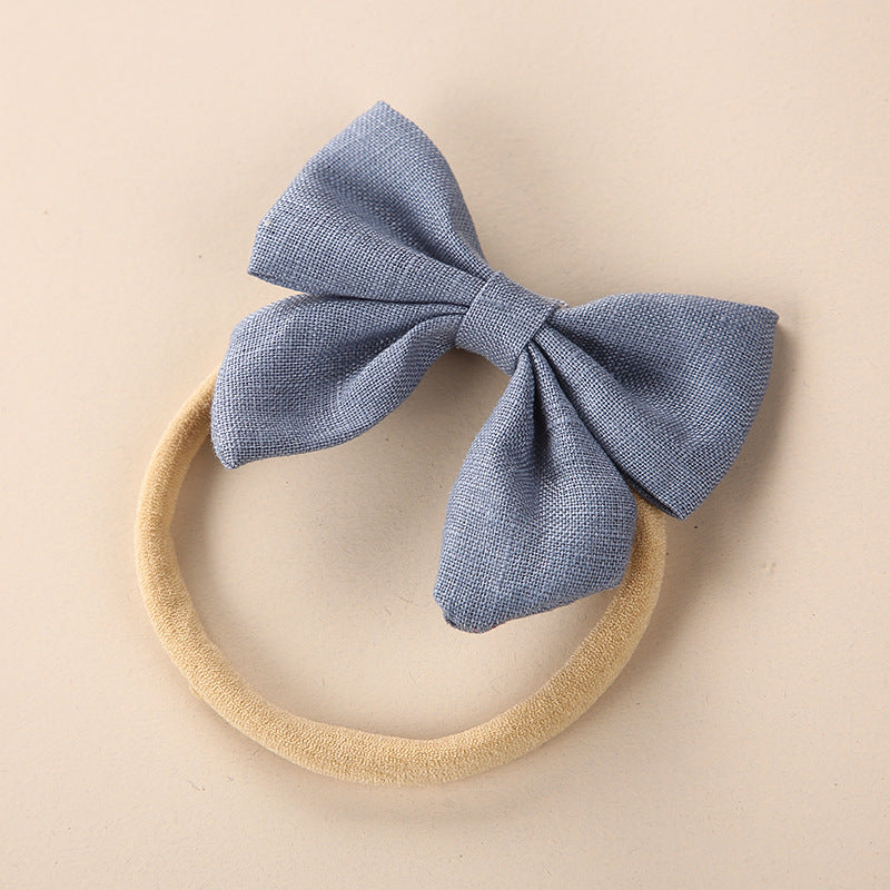 A collection of Baby Solid Color 3D Bow Handmade Elastic Headbands in various colors, showcasing their soft cotton material and adjustable design.