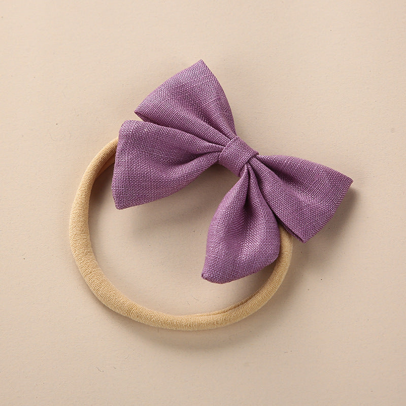 A collection of Baby Solid Color 3D Bow Handmade Elastic Headbands in various colors, showcasing their soft cotton material and adjustable design.