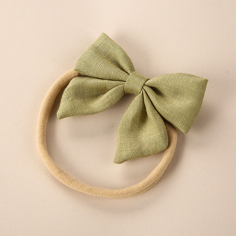 A collection of Baby Solid Color 3D Bow Handmade Elastic Headbands in various colors, showcasing their soft cotton material and adjustable design.