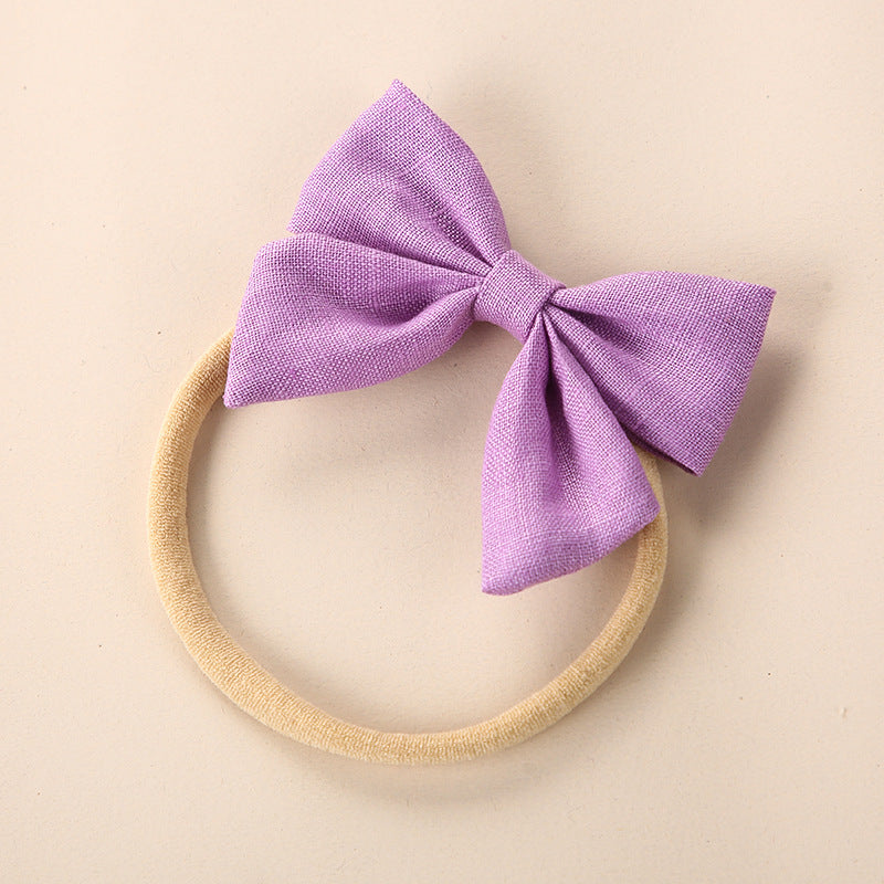 A collection of Baby Solid Color 3D Bow Handmade Elastic Headbands in various colors, showcasing their soft cotton material and adjustable design.