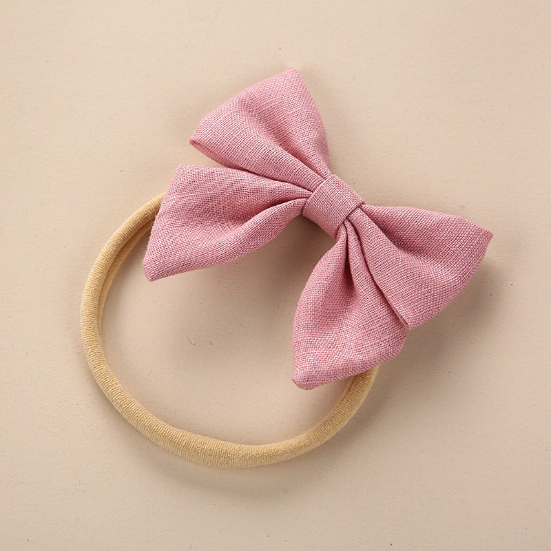 A collection of Baby Solid Color 3D Bow Handmade Elastic Headbands in various colors, showcasing their soft cotton material and adjustable design.