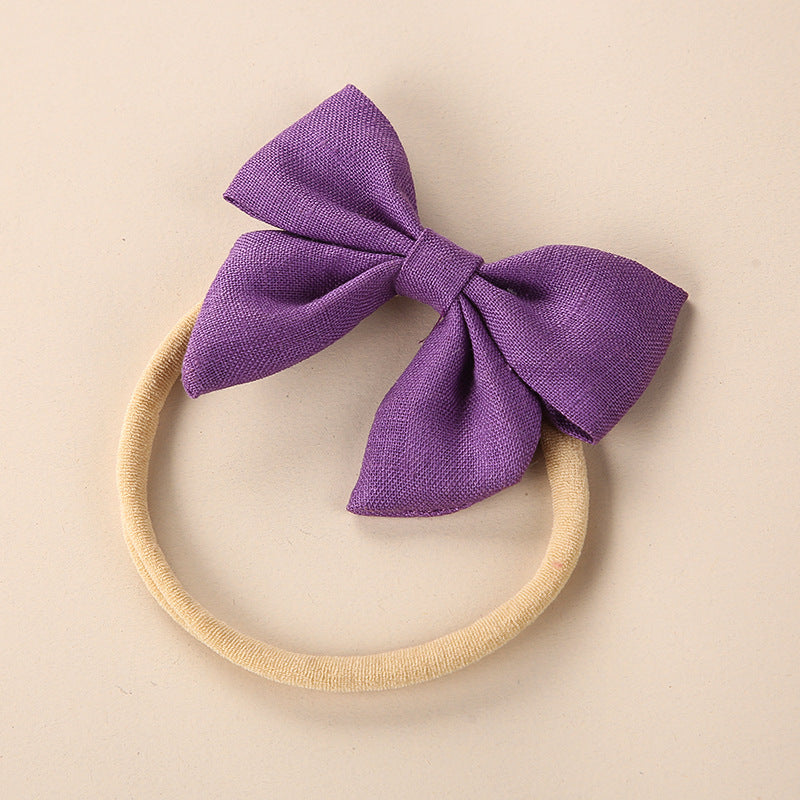 A collection of Baby Solid Color 3D Bow Handmade Elastic Headbands in various colors, showcasing their soft cotton material and adjustable design.