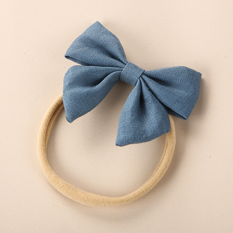 A collection of Baby Solid Color 3D Bow Handmade Elastic Headbands in various colors, showcasing their soft cotton material and adjustable design.