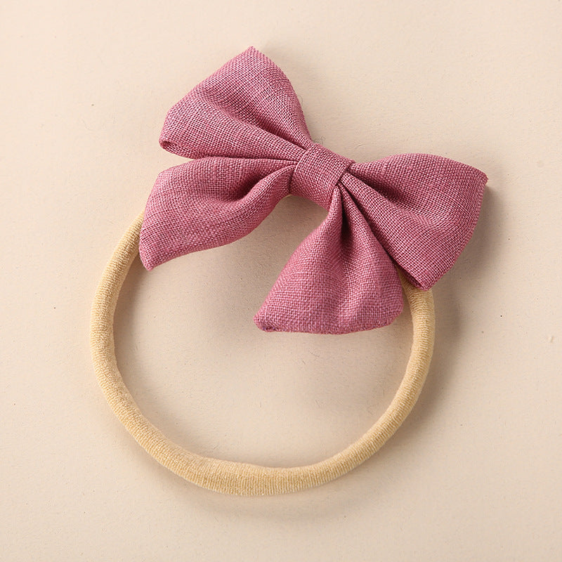 A collection of Baby Solid Color 3D Bow Handmade Elastic Headbands in various colors, showcasing their soft cotton material and adjustable design.