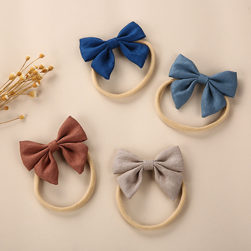 A collection of Baby Solid Color 3D Bow Handmade Elastic Headbands in various colors, showcasing their soft cotton material and adjustable design.