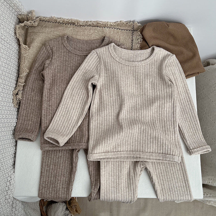 Baby solid color comfy fabric shirt sets in grey and apricot, perfect for lounging at home.