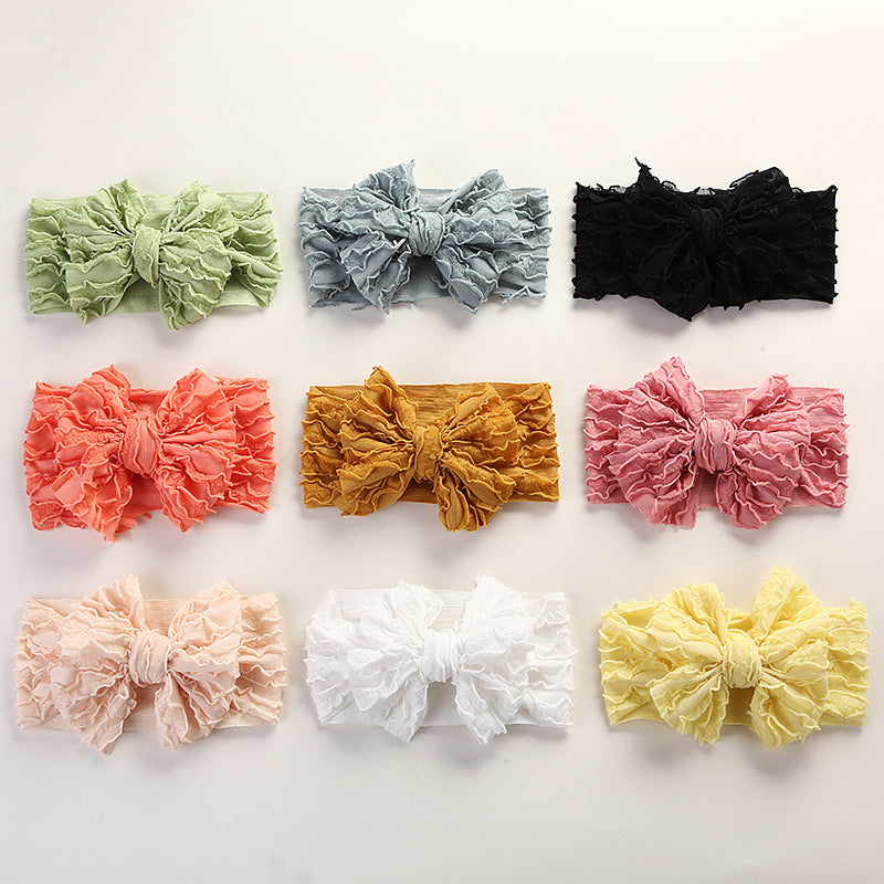 A colorful collection of Baby Solid Color Elastic Handmade Big Bow Headbands displayed, showcasing various colors and the large bow design.