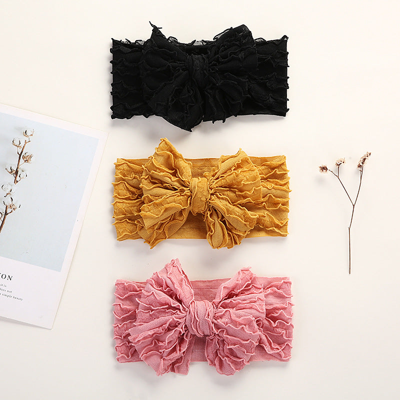 A colorful collection of Baby Solid Color Elastic Handmade Big Bow Headbands displayed, showcasing various colors and the large bow design.