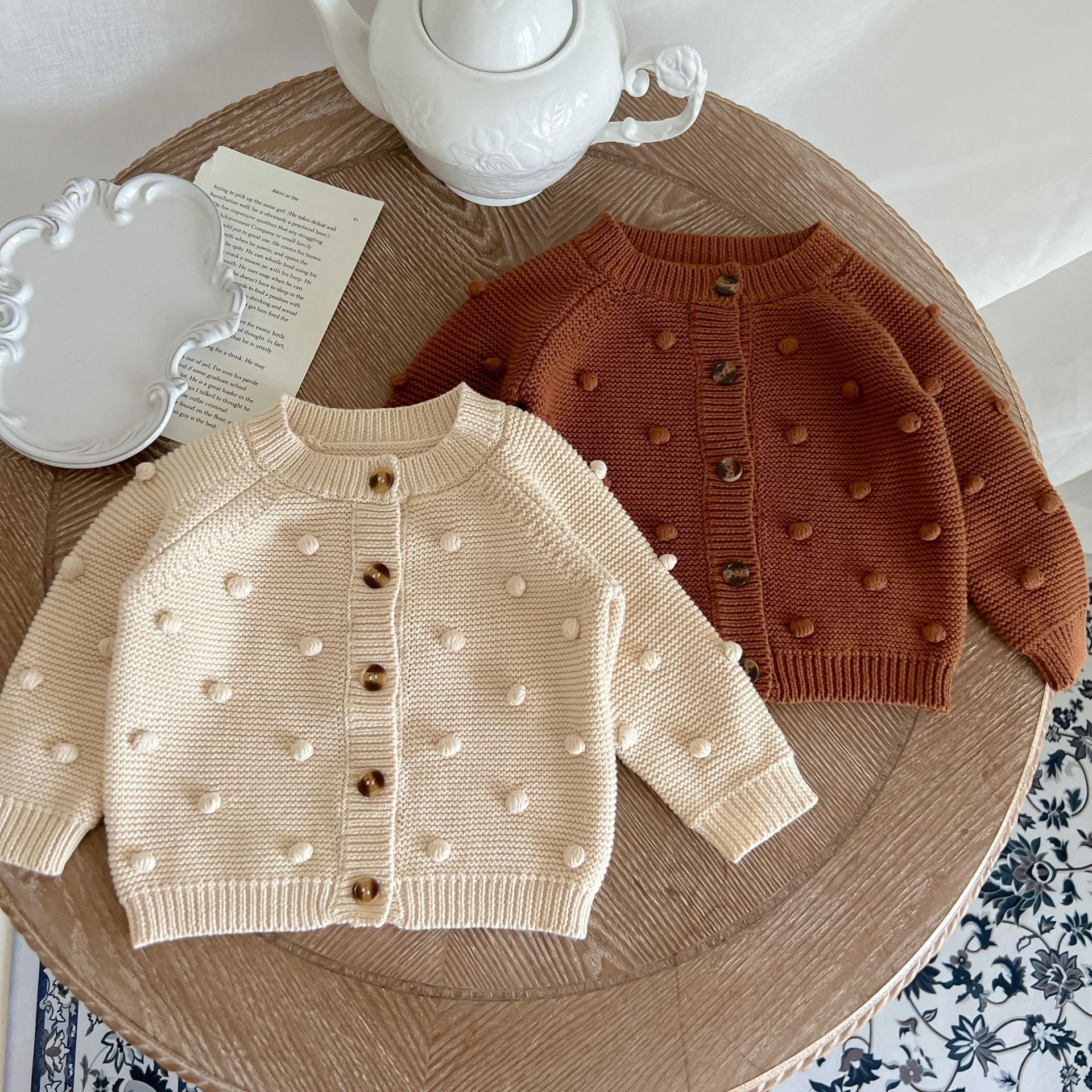 Baby Solid Color Cardigan with Fur-Ball Patches in apricot and brown, showcasing soft cotton material and stylish design.