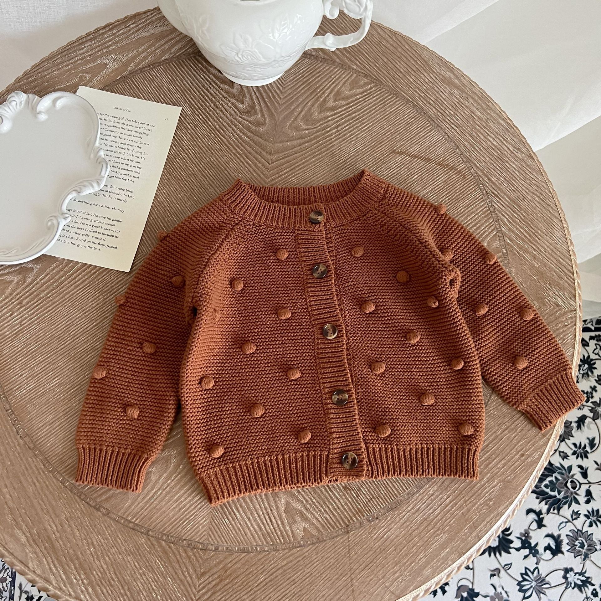 Baby Solid Color Cardigan with Fur-Ball Patches in apricot and brown, showcasing soft cotton material and stylish design.