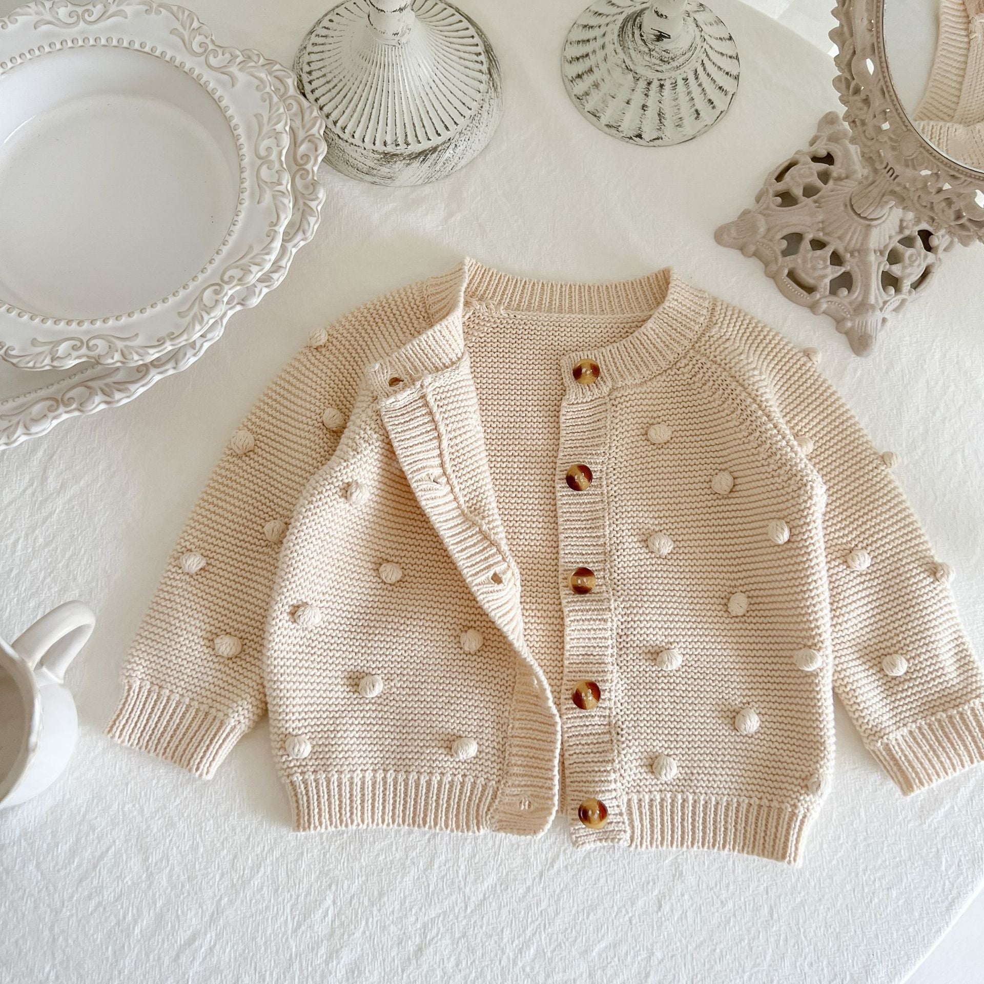 Baby Solid Color Cardigan with Fur-Ball Patches in apricot and brown, showcasing soft cotton material and stylish design.