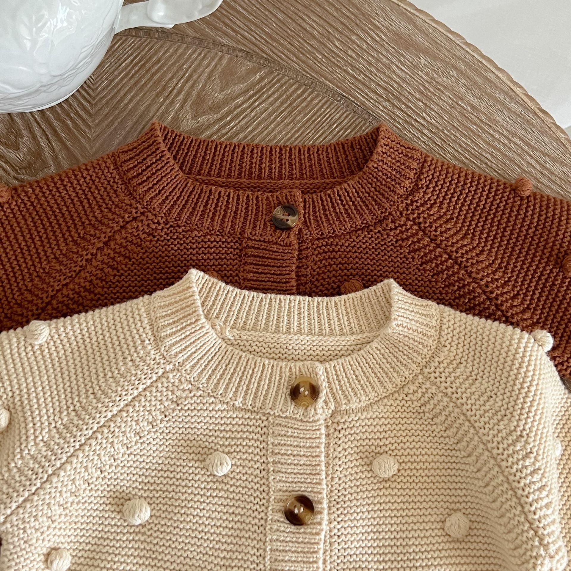 Baby Solid Color Cardigan with Fur-Ball Patches in apricot and brown, showcasing soft cotton material and stylish design.