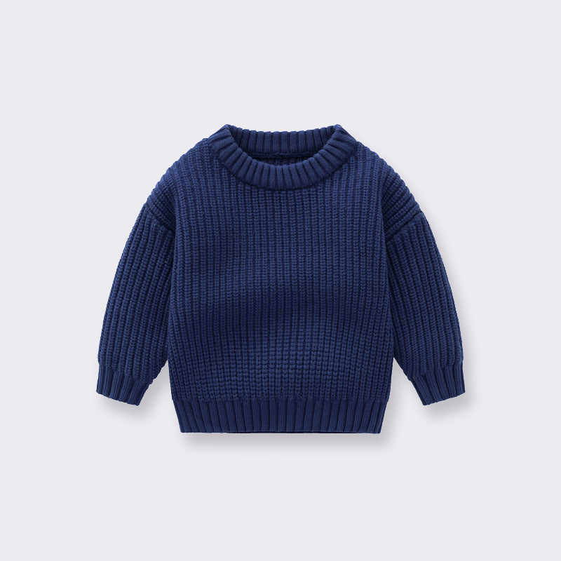 A cozy handknit baby pullover sweater in solid colors, perfect for boys and girls.