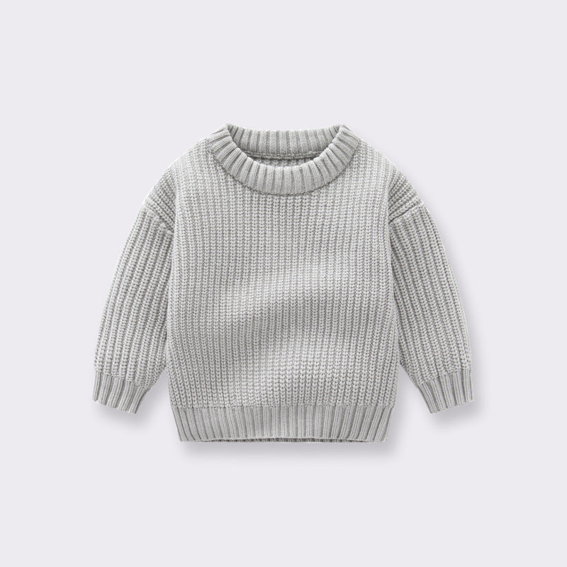 A cozy handknit baby pullover sweater in solid colors, perfect for boys and girls.