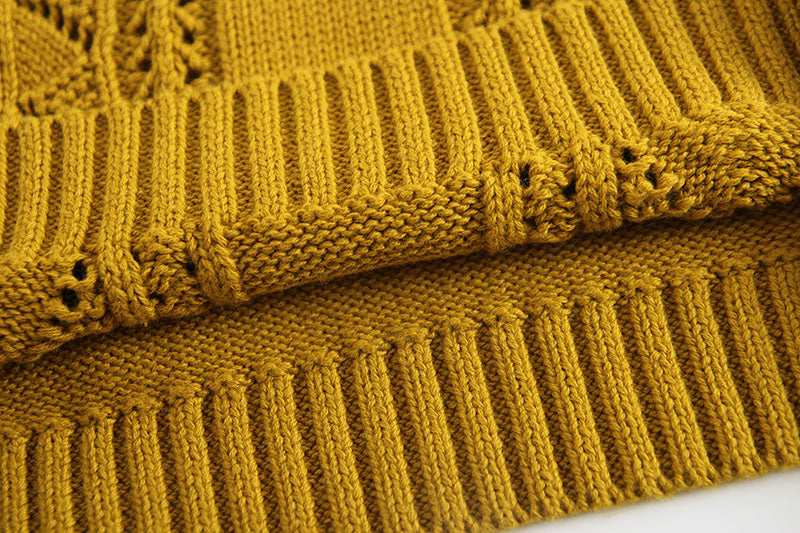 Baby girl wearing a solid color hollow carved knitwear set in white and yellow, showcasing a charming design.