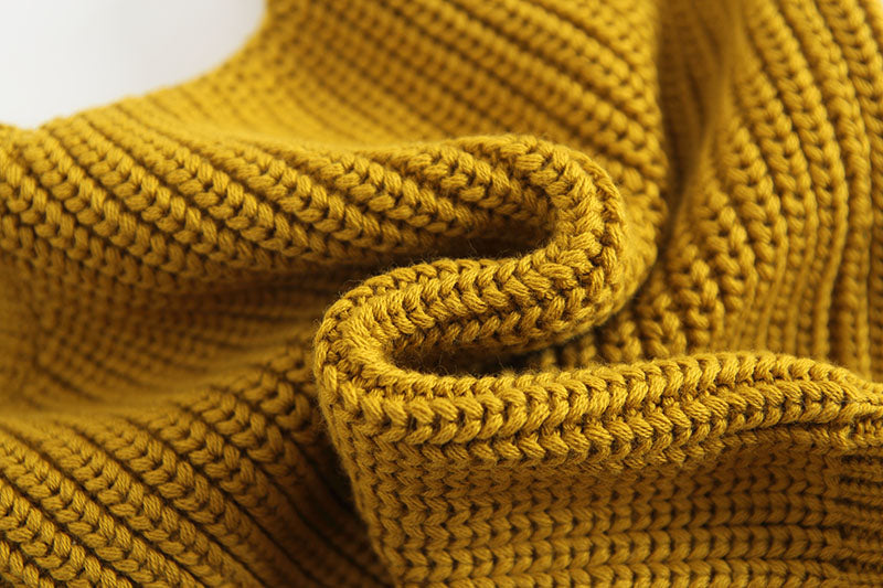 Baby girl wearing a solid color hollow carved knitwear set in white and yellow, showcasing a charming design.