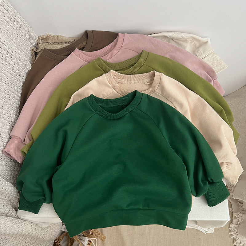 A collection of Baby Solid Color Long Sleeve Pullover Crewneck Hoodies in various colors including pink, green, and apricot, displayed neatly.