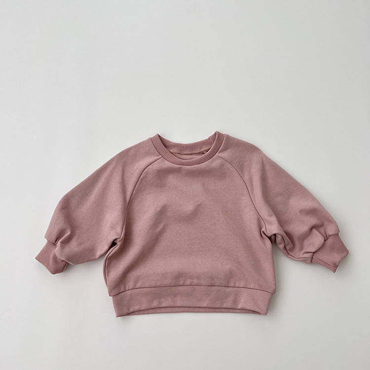 A collection of Baby Solid Color Long Sleeve Pullover Crewneck Hoodies in various colors including pink, green, and apricot, displayed neatly.