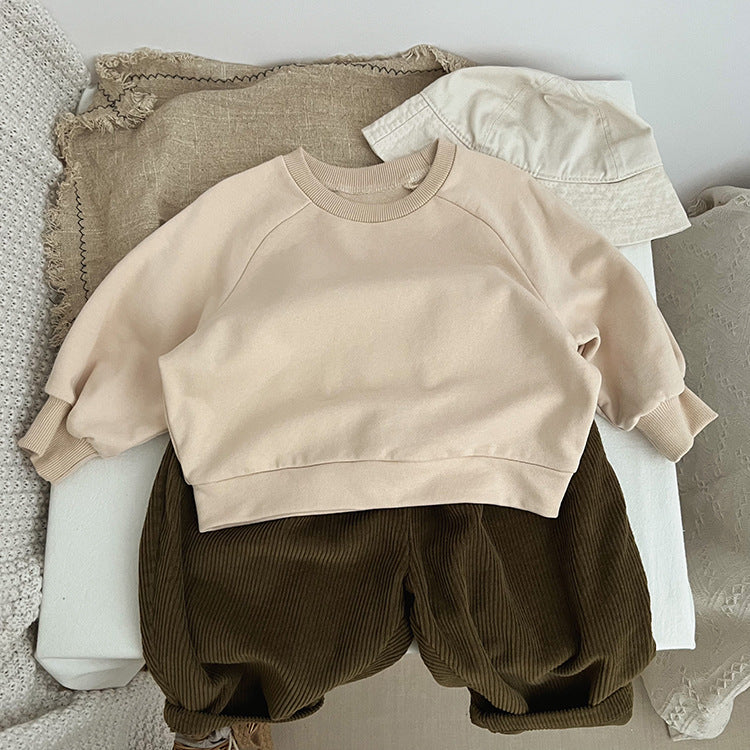 A collection of Baby Solid Color Long Sleeve Pullover Crewneck Hoodies in various colors including pink, green, and apricot, displayed neatly.