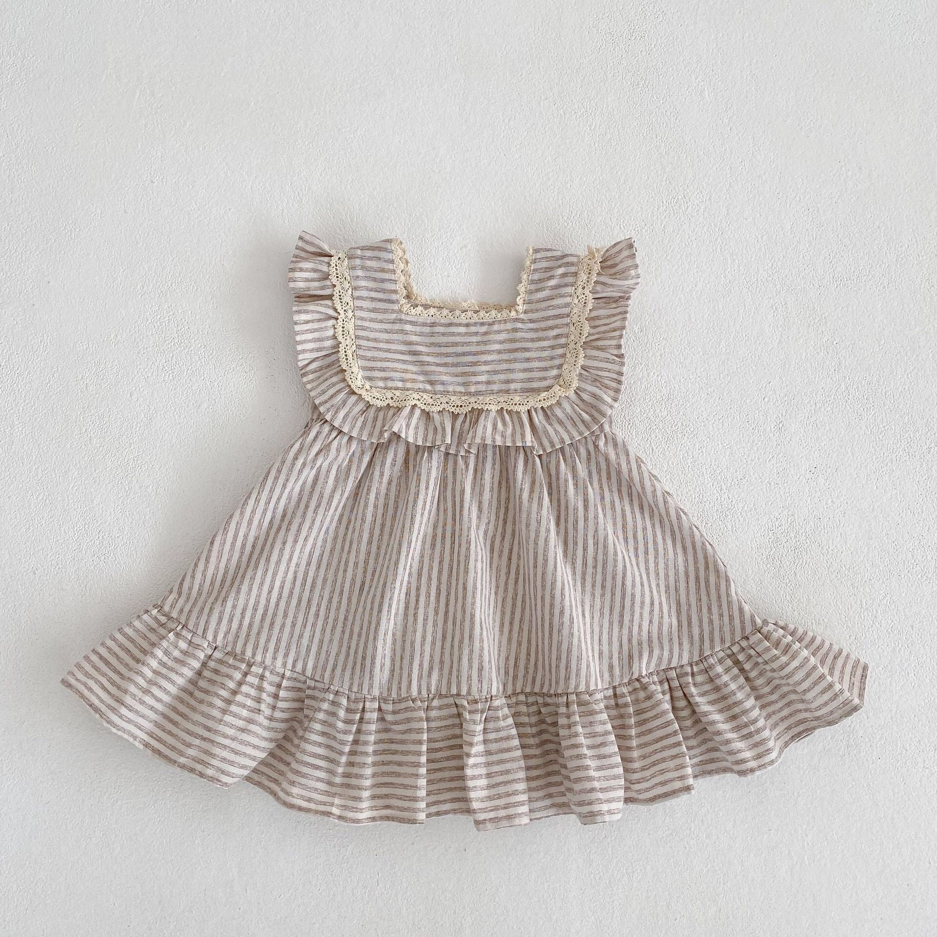 Baby girl wearing a striped sleeveless princess dress in green and light green, showcasing a playful summer style.